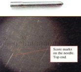 Score marks on the top needle
